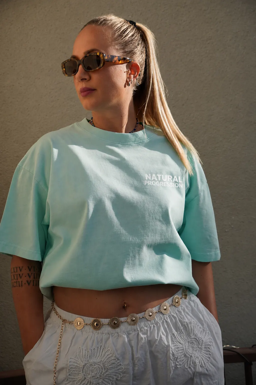 Natural Progression blue T-shirt worn outdoors